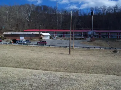 a parking lot with cars parked in front of a building at Rodeway Inn South Point in South Point