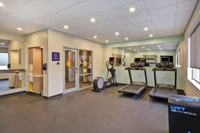 a gym with treadmills and ellipticals in a room at Tru By Hilton Beavercreek Dayton in Fairborn