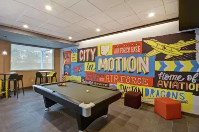 a game room with a pool table and signs on the wall at Tru By Hilton Beavercreek Dayton in Fairborn