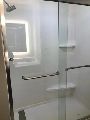 a glass shower door with a window in a bathroom at Holiday Inn Express - Toledo West - Napoleon by IHG in Napoleon