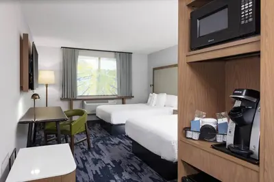 a hotel room with two beds and a television at Fairfield Inn & Suites by Marriott Indianapolis Greenfield in Greenfield