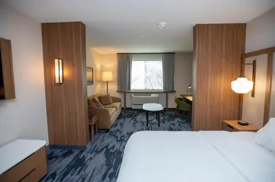 a hotel room with a bed and a couch at Fairfield Inn & Suites by Marriott Indianapolis Greenfield in Greenfield
