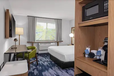 a hotel room with a bed and a desk at Fairfield Inn & Suites by Marriott Indianapolis Greenfield in Greenfield