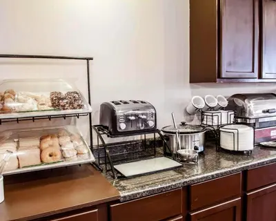 a kitchen counter with a bunch of food on it at Baymont by Wyndham Richmond I-70 in Richmond