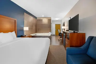 a hotel room with a bed and a television at Comfort Inn & Suites North Greenfield in Greenfield