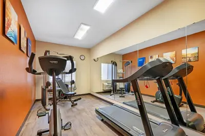 a gym with treadmills and ellipticals in a room at Comfort Inn & Suites North Greenfield in Greenfield