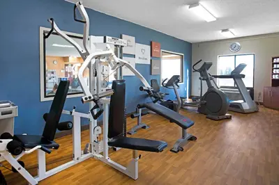 a gym with several exercise equipment in a room at Comfort Suites Fort Wayne North in Fort Wayne