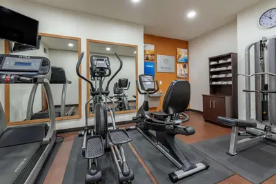 a gym with several exercise equipment in a room at Comfort Suites Auburn near I-69 in Auburn
