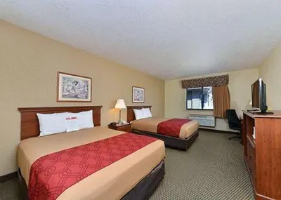 a hotel room with two beds and a television at Express Inn & suites in Decatur