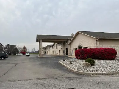 a building with a car parked in a parking lot at Express Inn & suites in Decatur