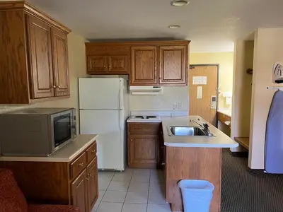 a kitchen with a white refrigerator and a sink at Express Inn & suites in Decatur