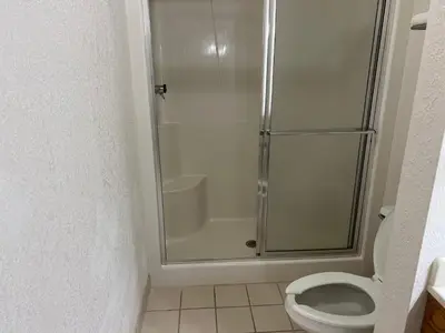a bathroom with a shower and a toilet at Express Inn & suites in Decatur