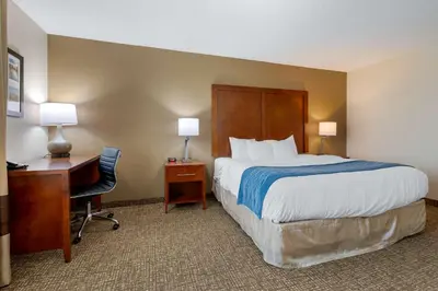 a hotel room with a bed and a desk and a bed sidx sidx sidx sidx at Comfort Inn Anderson South in Anderson