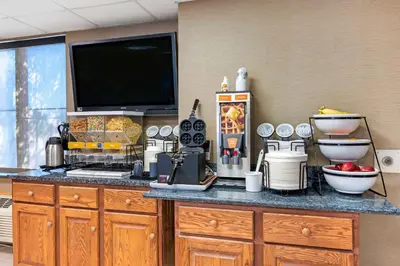 a kitchen with a counter with a tv on top at Comfort Inn Anderson South in Anderson