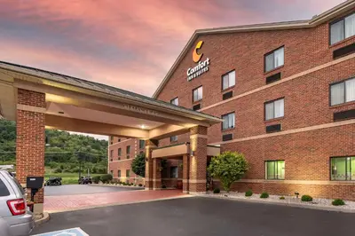 a hotel with a parking lot in front of a building at Comfort Inn & Suites Lawrenceburg in Lawrenceburg
