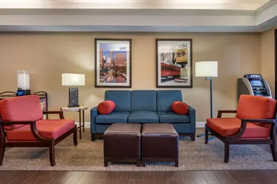 a living room with a couch and two chairs at Comfort Inn & Suites Lawrenceburg in Lawrenceburg