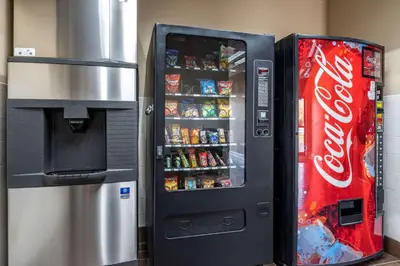 a cocacola soda vending machine next to a refrigerator at Comfort Inn & Suites Lawrenceburg in Lawrenceburg