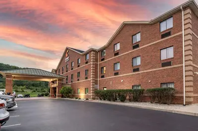a building with a parking lot in front of it at Comfort Inn & Suites Lawrenceburg in Lawrenceburg