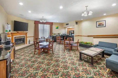 a living room with a couch and a table at Quality Inn & Suites Near Amish Country in Rushville
