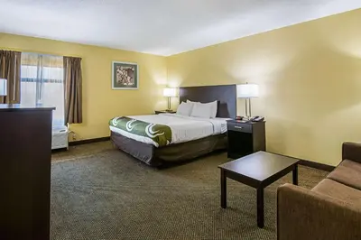 a hotel room with a bed and a couch at Quality Inn & Suites Greensburg I-74 in Greensburg
