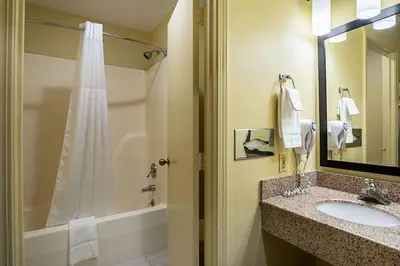 a bathroom with a shower and a sink and a tub at Quality Inn & Suites Greensburg I-74 in Greensburg