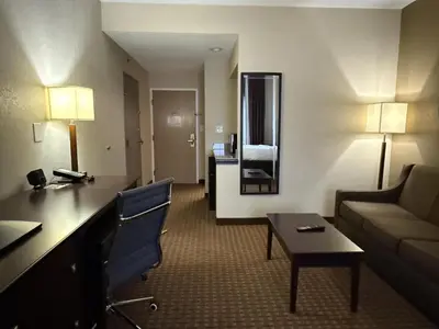a hotel room with a couch and a living room at SureStay by Best Western Marion in Marion