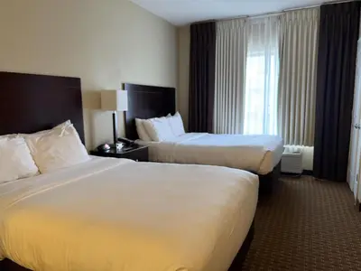 a hotel room with two beds and a window at SureStay by Best Western Marion in Marion
