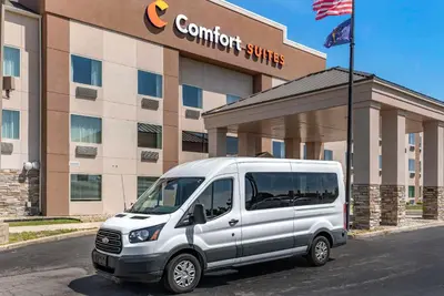 a white van parked in front of a building at Comfort Suites Fort Wayne - Southwest in Fort Wayne