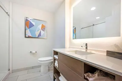 a bathroom with a sink and a toilet and a mirror at Comfort Suites Fort Wayne - Southwest in Fort Wayne