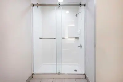 a shower with a glass door in a bathroom at Comfort Suites Fort Wayne - Southwest in Fort Wayne