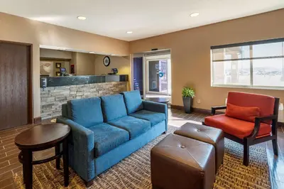 a living room with a blue couch and two chairs at Comfort Inn Shelbyville North in Shelbyville