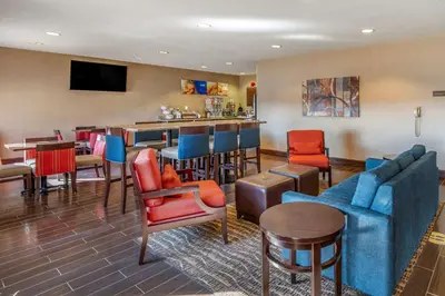 a lobby with a bar and some chairs and tables at Comfort Inn Shelbyville North in Shelbyville