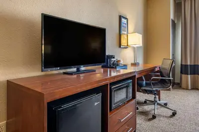 a room with a desk with a flat screen tv at Comfort Inn Shelbyville North in Shelbyville