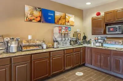a large kitchen with wooden cabinets and a counter top at Comfort Inn Shelbyville North in Shelbyville