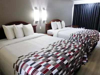 a hotel room with two beds in a room at Red Roof Inn Walton, KY - Richwood - Cincinnati Airport South in Richwood