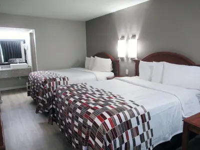 a hotel room with two beds and a mirror at Red Roof Inn Walton, KY - Richwood - Cincinnati Airport South in Richwood