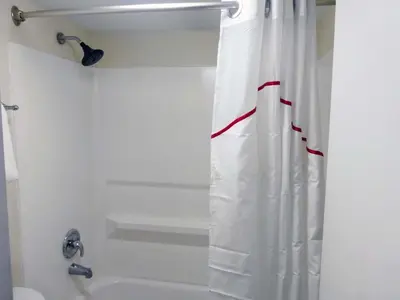 a bathroom with a shower with a white shower curtain at Red Roof Inn Walton, KY - Richwood - Cincinnati Airport South in Richwood