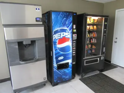 a pepsi cola vending machine next to a refrigerator at Red Roof Inn Walton, KY - Richwood - Cincinnati Airport South in Richwood