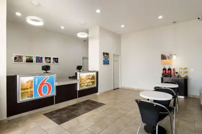 a restaurant with a table and a tv in a room at Motel 6-Lexington, KY - Airport in Lexington