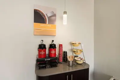 a small table with bottles of wine on it at Motel 6-Lexington, KY - Airport in Lexington