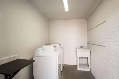 a laundry room with white walls and white appliances at Motel 6-Lexington, KY - Airport in Lexington