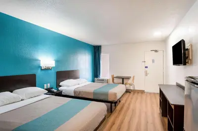 a hotel room with two beds and a blue wall at Motel 6-Lexington, KY - Airport in Lexington
