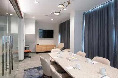 a meeting room with a table and chairs at Fairfield by Marriott Inn & Suites Newport Cincinnati in Newport