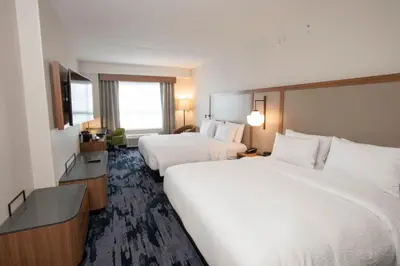 a hotel room with two beds and a television at Fairfield by Marriott Inn & Suites Newport Cincinnati in Newport