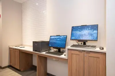 two computer monitors on a desk in a room at Fairfield by Marriott Inn & Suites Newport Cincinnati in Newport