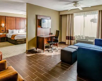 a hotel room with a bed and a desk at Comfort Suites Georgetown in Georgetown