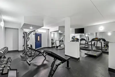 a gym with several treadmills and cardio machines at Spark by Hilton Lexington Hamburg in Lexington