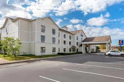 a building with a car parked in front of a parking lot at Comfort Inn & Suites Morehead in Morehead