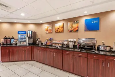 a lobby with a counter with a coffee shop at Comfort Inn & Suites Morehead in Morehead