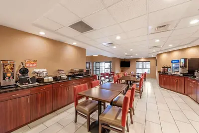 a restaurant with tables and chairs and a cafeteria at Comfort Inn & Suites Morehead in Morehead